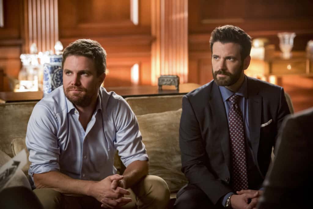 Arrow Season 8 Episode 1 - Stephen Amell as Oliver Queen/Green Arrow and Colin Donnell as Tommy Merlyn
