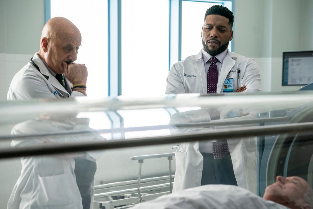 New Amsterdam Season 2 Episode 15, "Double Blind" Pictured: (l-r) Anupam Kher as Dr. Vijay Kapoor, Jocko Sims as Dr. Floyd Reynolds, Thomas Benton as Joe Hildebrandt