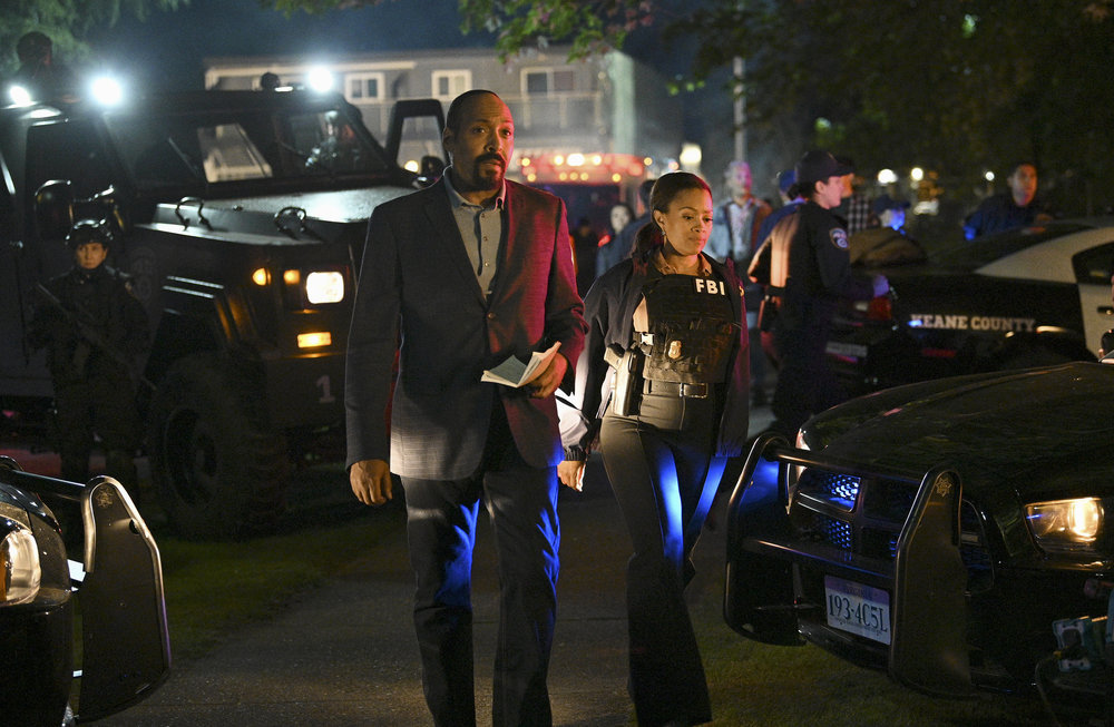Still from The Irrational Season 1 Episode 1 - Jesse L. Martin as Alec Mercer, Maahra Hill as Marisa alking together at an outdoor night time crime scene