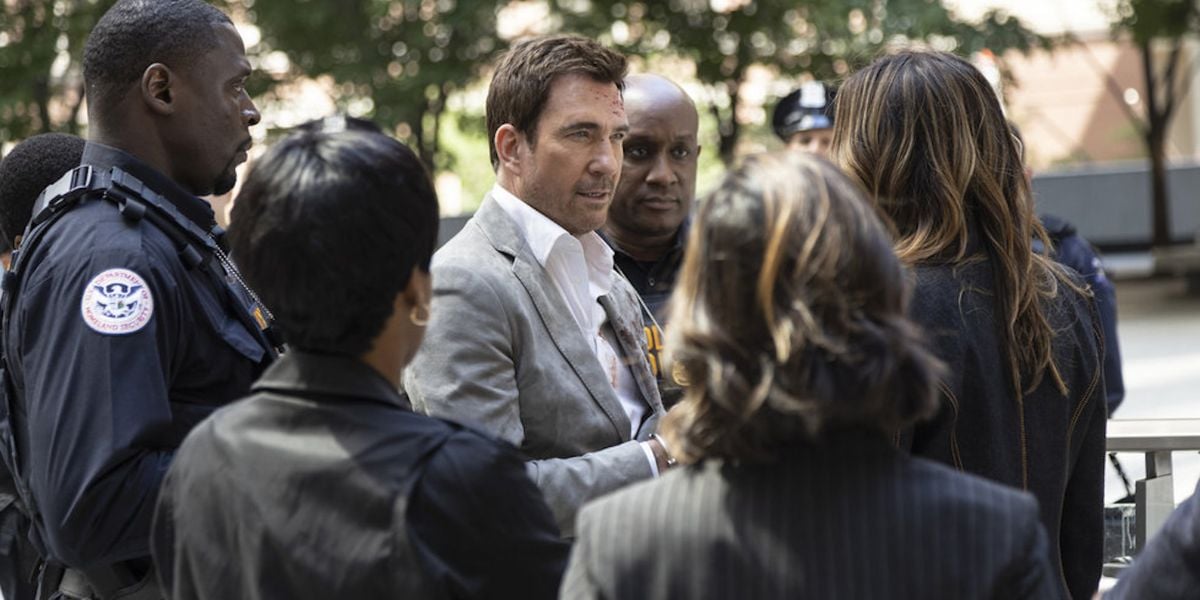 Richard Wheatley facing Olivia Benson in a crowd of police officers.