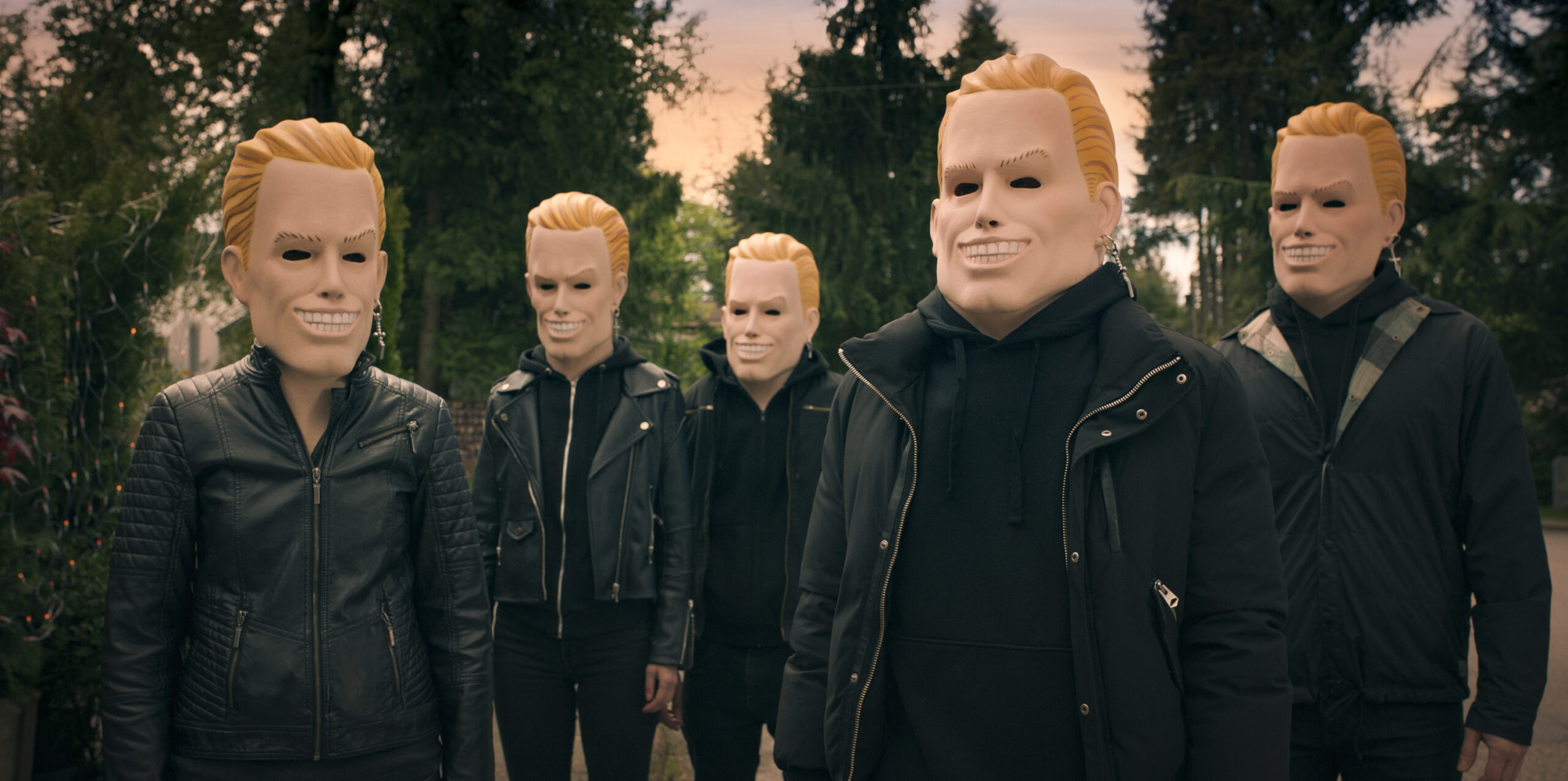 Totally Killer | Tell-Tale TV Still from Totally Killer of a group of people wearing masks and black clothes dressed as the Sweet 16 Killer