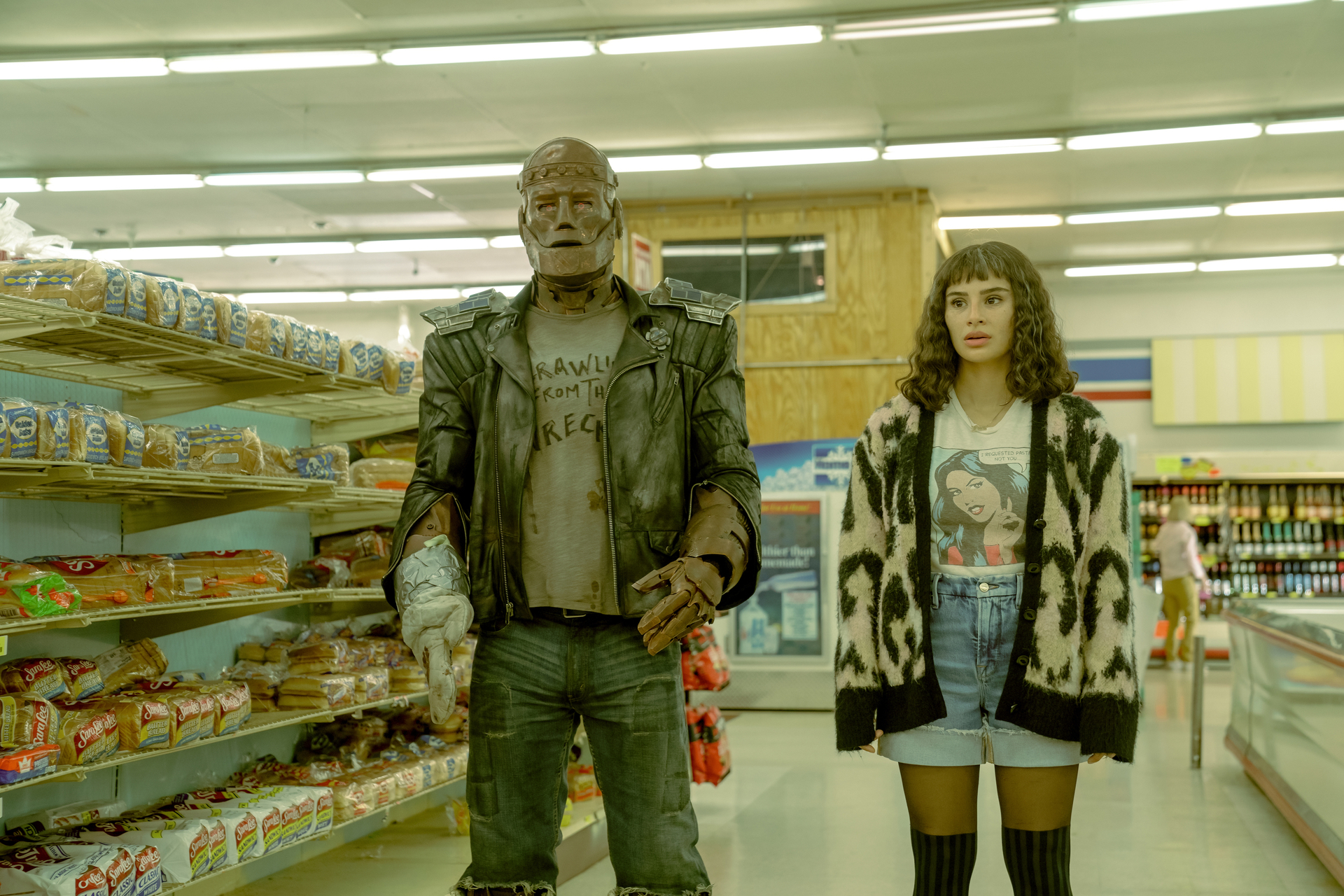 Doom Patrol Season 4 Episode 6 - Diane Guerrero and Brendan Fraser | Tell-Tale TV Still fro Doom Patrol Season 4 Episode 7 of Brendan Fraser as Cliff and Diane Guerrero Jane walking in a grocery store