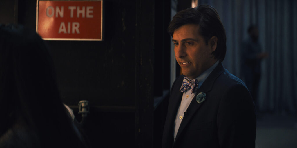 Quiz Lady - Jason Schwartzman | Tell-Tale TV Still from the film Quiz Lady of Jason Schwartzman as Ron Heacock.