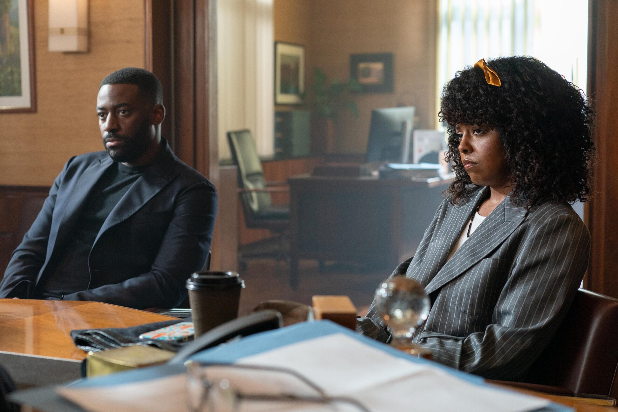 Still from Black Cake Season 1 Episode 1 of Ashley Thomas as Byron and Adrienne Warren as Benny.