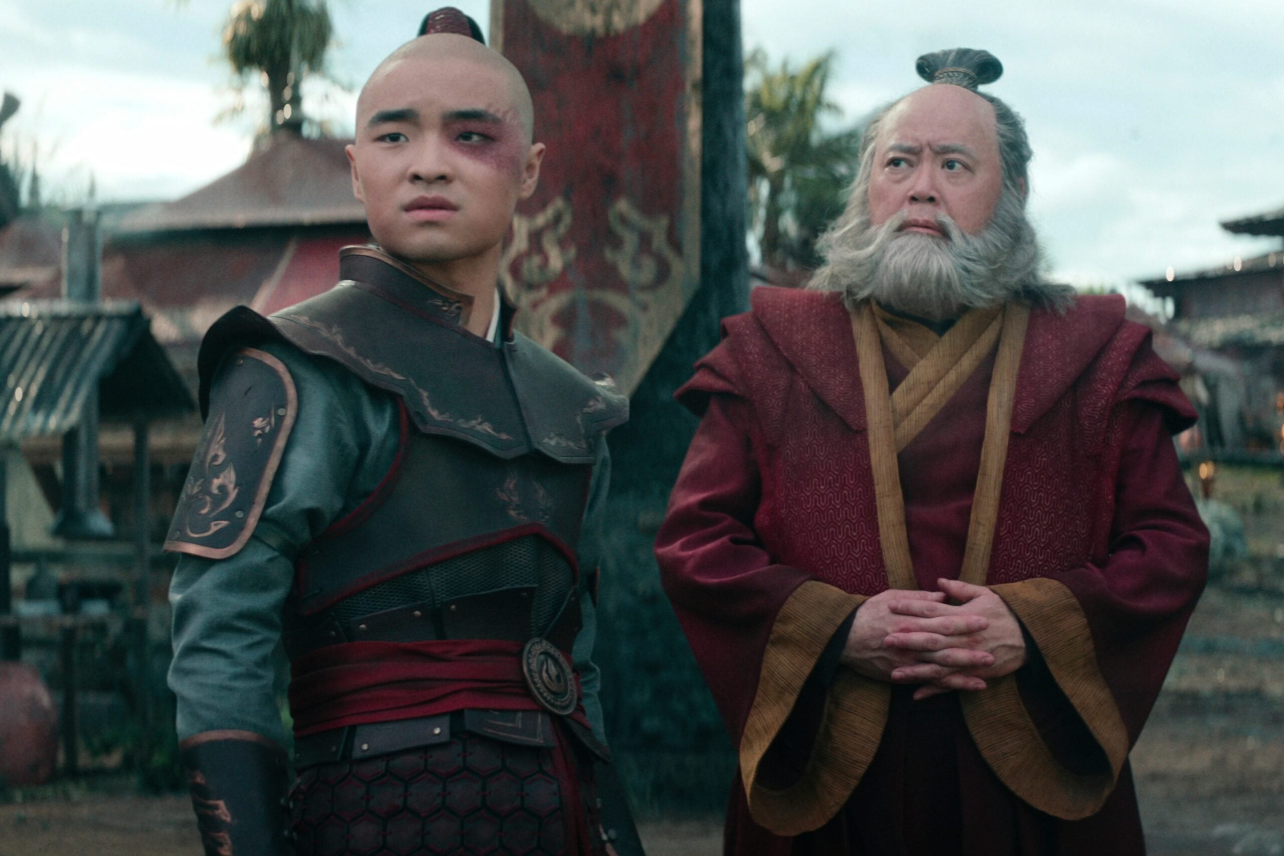 Still from the live action Netflix series Avatar: The Last Airbender of Dallas Liu as Prince Zuko and Paul Sun-Hyung Lee as Iroh pictured from left to right