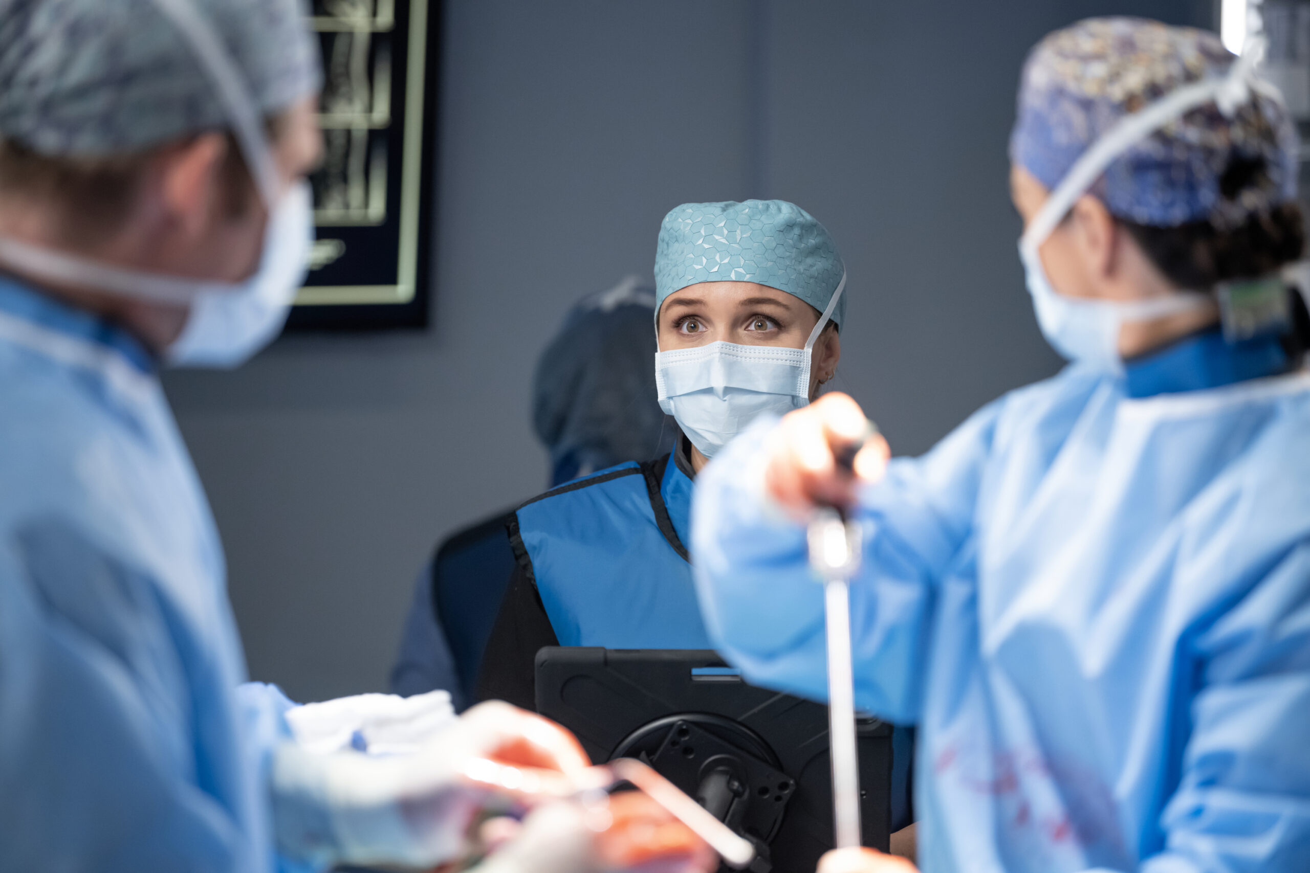 Jo looks alarmed in the OR, wearing mask and cap. Camilla Luddington plays the role of Jo. Grey's Anatomy Season 20 Episode 2, "Keep the Family Close."