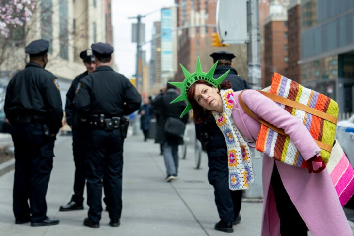 Carrie Preston as Elsbeth Tascioni - Elsbeth Season 1 Episode 1 | Tell-Tale TV Carrie Preston as Elsbeth Tascioni wearing a statue of liberty hat and dressed in a pink coat and colorful scarf, excited to be in New York City - Elsbeth Season 1 Episode 1 - pilot episode still, spinoff of The Good Wife How to Watch ‘Elsbeth,’ the Next Spinoff of ‘The Good Wife’ Carrie Preston stars as Elsbeth Tascioni in ELSBETH, a new drama based on the character featured in THE GOOD WIFE and THE GOOD FIGHT. The show follows Elsbeth Tascioni, an astute but unconventional attorney who, after her successful career in Chicago, utilizes her singular point of view to make unique observations and corner brilliant criminals alongside the NYPD. ELSBETH premiers in the 2023-2024 season on the CBS Television Network, and available to stream live and on demand on Paramount+. Pictured: Carrie Preston as Elsbeth Tascioni. Photo: Elizabeth Fisher/CBS ©2023 CBS Broadcasting, Inc. All Rights Reserved.