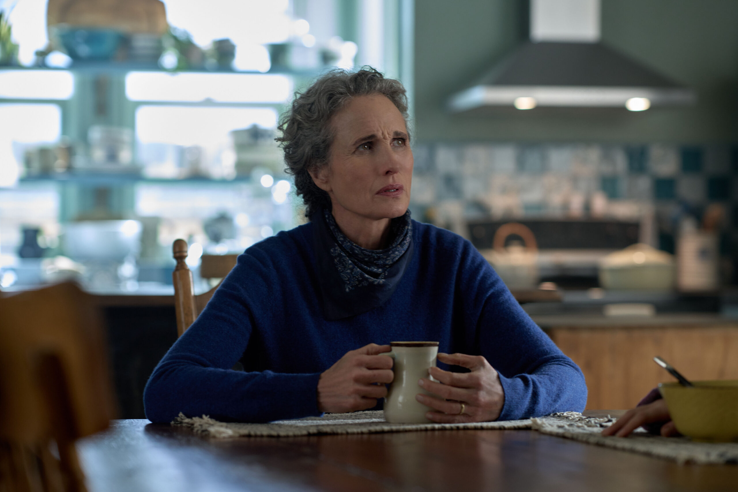 Andie MacDowell as Del Landry, at the table with coffee, on The Way Home Season 2 Episode 10