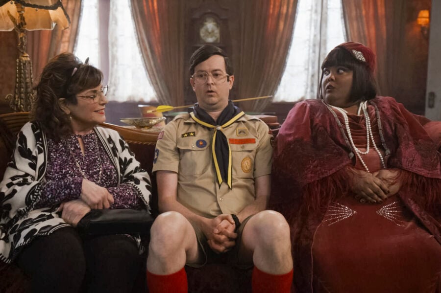 Carol, Pete, and Alberta on the couch. Pete looks shocked. Ghosts Season 3 Episode 5, titled, "The Silent Partner"