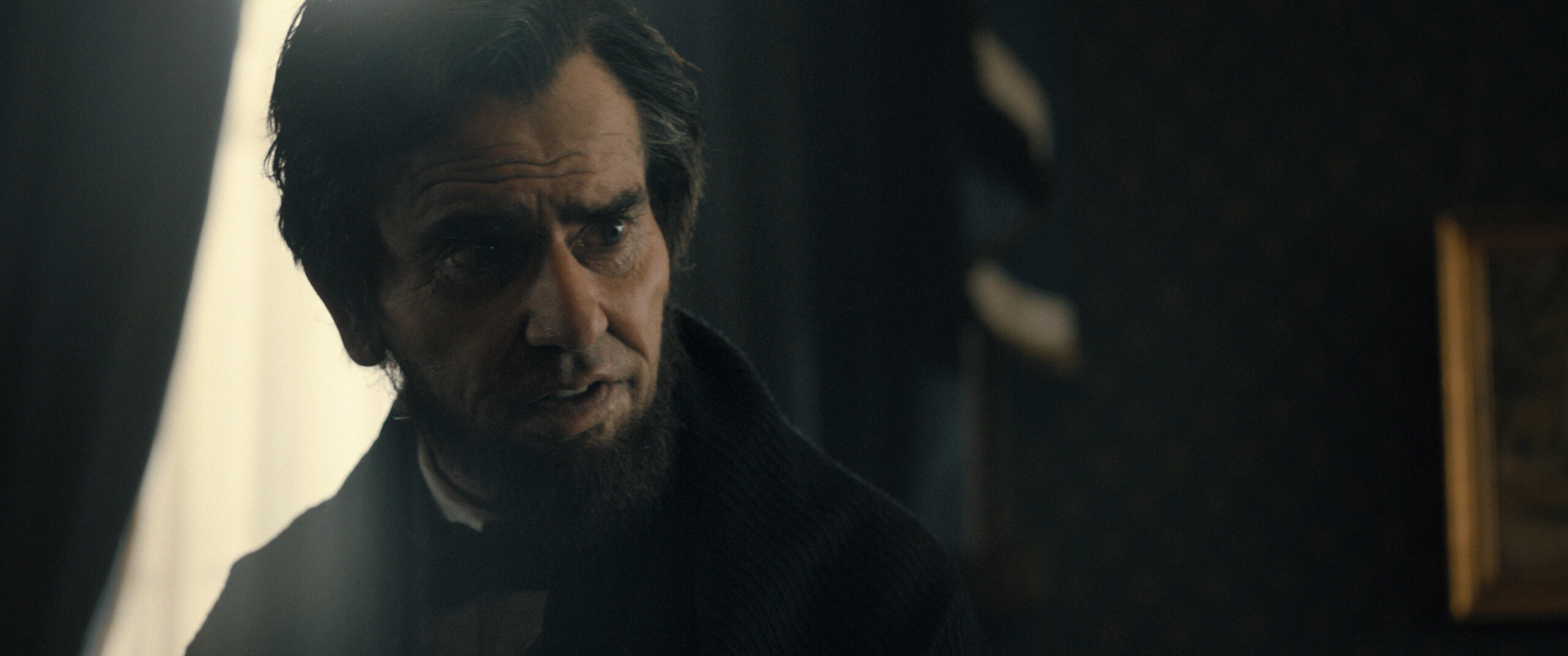 Still from Manhunt Season 1 Episode 3 of Hamish Linklater as Abraham Lincoln in a medium close shot of his face.