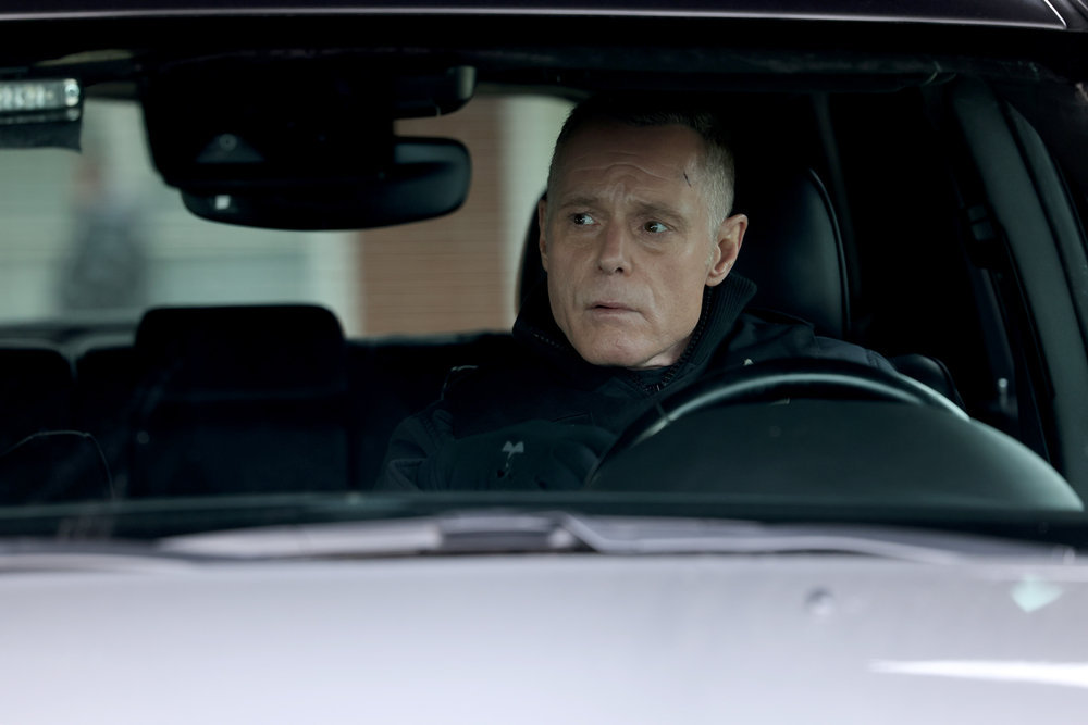 Chicago P.D. Season 11 Episode 7, Jason Beghe as Hank Voight sits in his car looking at something out of frame.