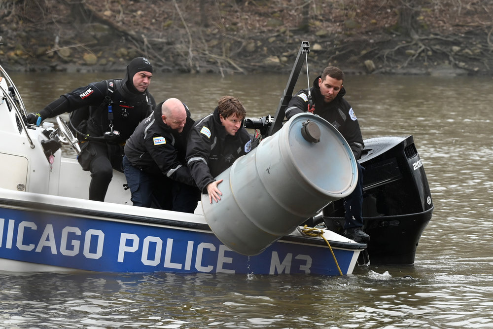 Chicago P.D. Season 11 Episode 7, Chicago Police officers pull a big metal drum out of the water.
