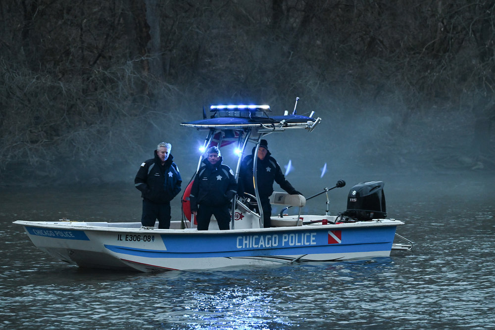Chicago P.D. Season 11 Episode 7, Chicago Police officers stand on a rescue boat combing a body of water.