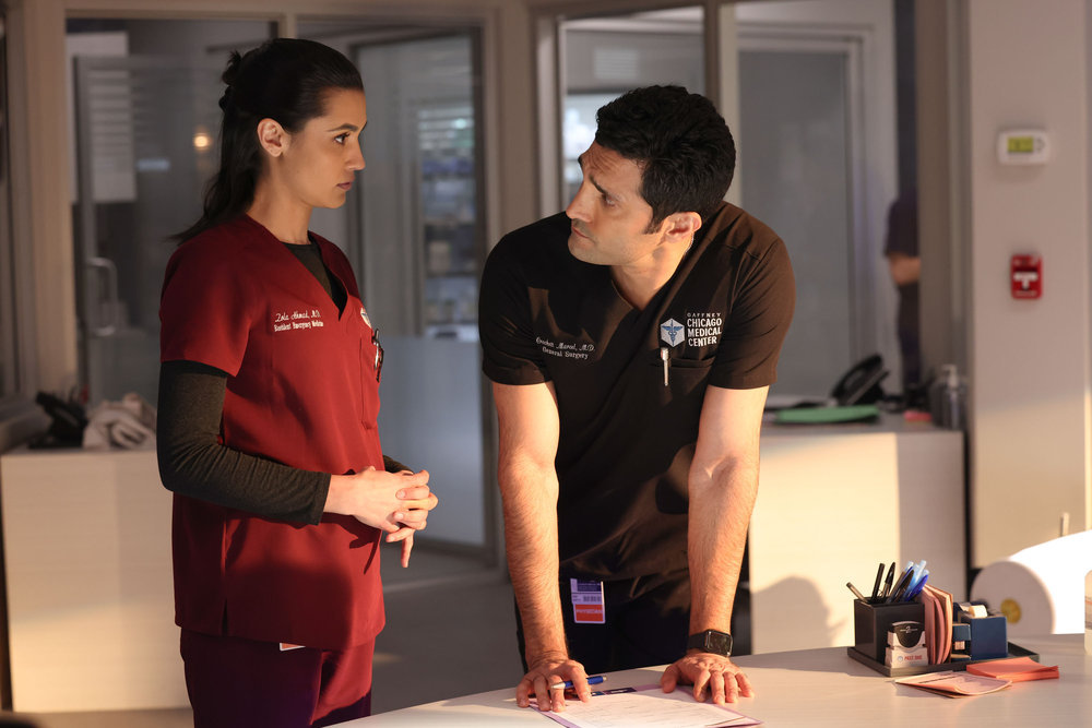 Chicago Med - Season 9 Episode 8 Sophia Ali as Dr. Zola Ahmed looks on concerned as Dominic Rains as Dr. Crockett Marcel leans on the table but looks back toward her to discuss something. Preview — Chicago Med Season 9 Episode 8: A Telepathic Patient Visits the ED Chicago Med - Season 9 Episode 8 Sophia Ali as Dr. Zola Ahmed looks on concerned as Dominic Rains as Dr. Crockett Marcel leans on the table but looks back toward her to discuss something.