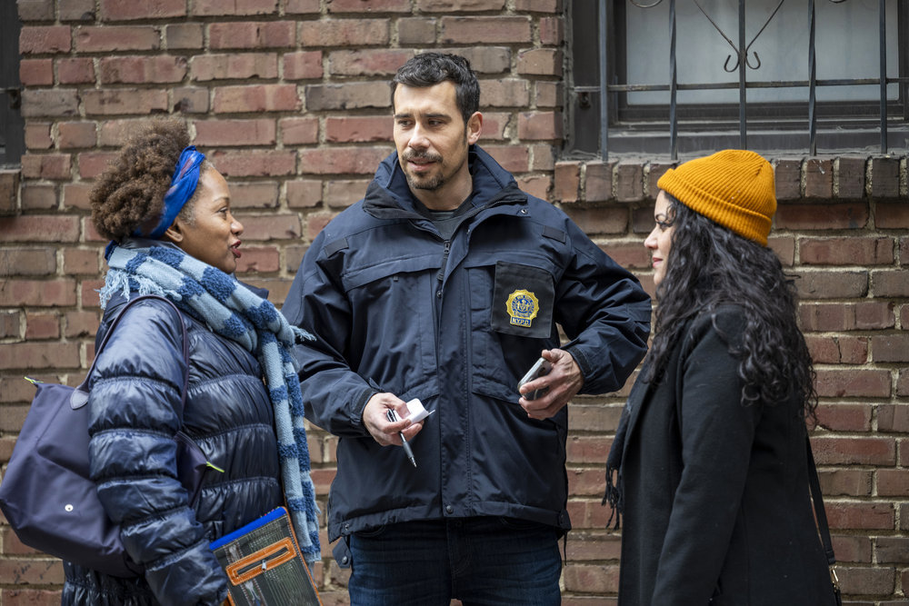 Law & Order: Special Victims Unit - Season 25 Episode 7, Octavio Pisano as Det. Joe Velasco questions two young women outside a brick building.