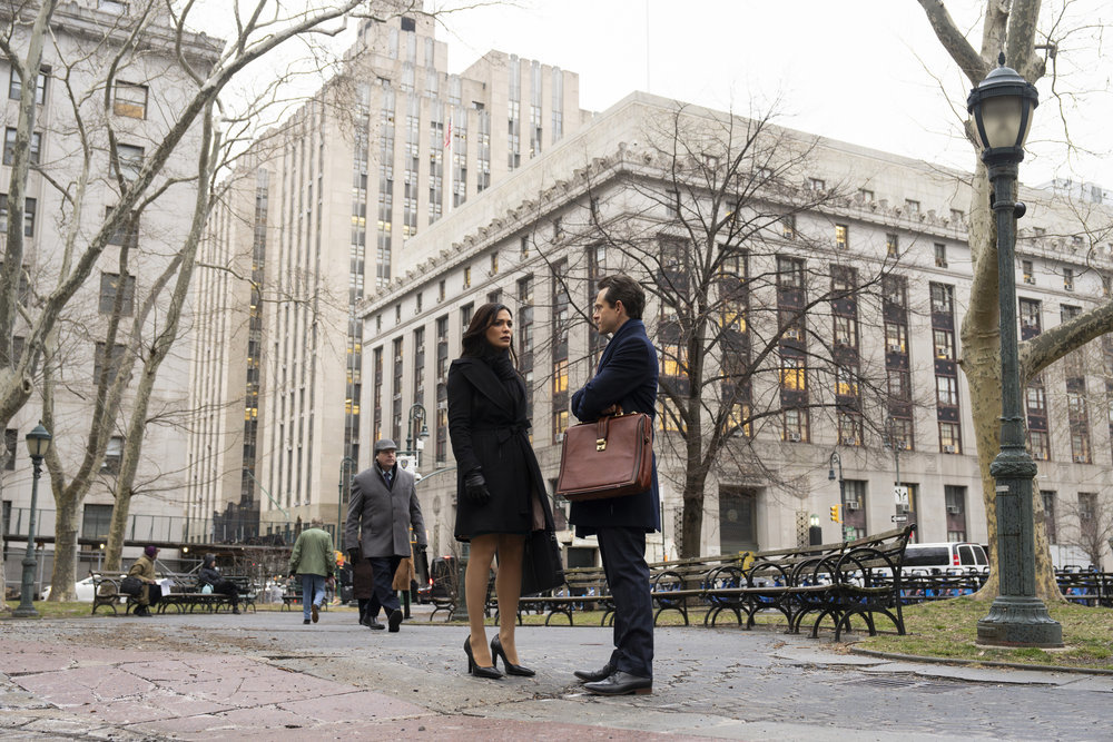 Law & Order - Season 23 | Tell-Tale TV Law & Order Season 23 Episode 8 - Odelyan Halevi and Hugh Dancy stand in the park near the courthouse discussing the case during the day.