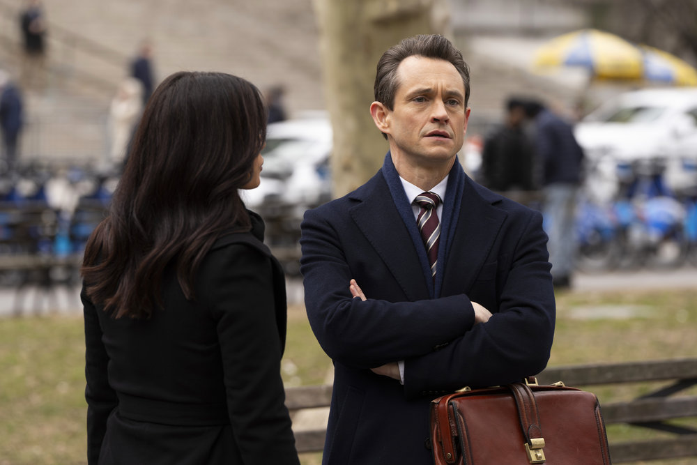 Law & Order - Season 23 | Tell-Tale TV Law & Order Season 23 Episode 8 - Odelya Halevi has her back to the camera as she stands with Hugh Dancy in the park near the courthouse during the day.