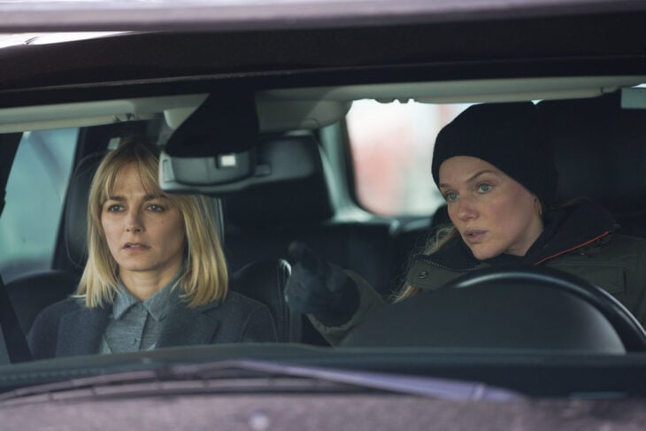 Chicago P.D. - Season 11 Episode 8 Bojana Novakovic as Josephine Petrovic and Tracy Spiridakos as Hailey Upton in the car together, Upton is driving and pointing to something outside.