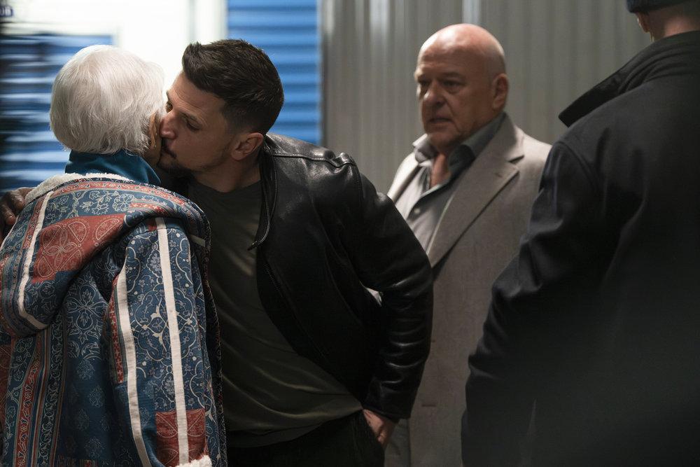 Law & Order: Organized Crime - Season 4 | Tell-Tale TV Law & Order: Organized Crime Season 4 Episode 8 - Ellen Burstyn, with her back to the camera, accepts a kiss on her cheek from Michael Trotter as Dean Norris and Christopher Meloni look on.