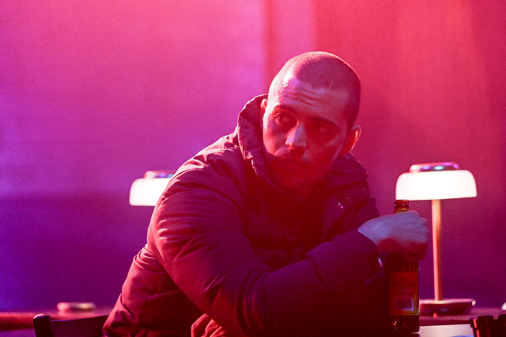 Chicago P.D. - Season 11 | Tell-Tale TV Torres leaning against a table next to a lamp.