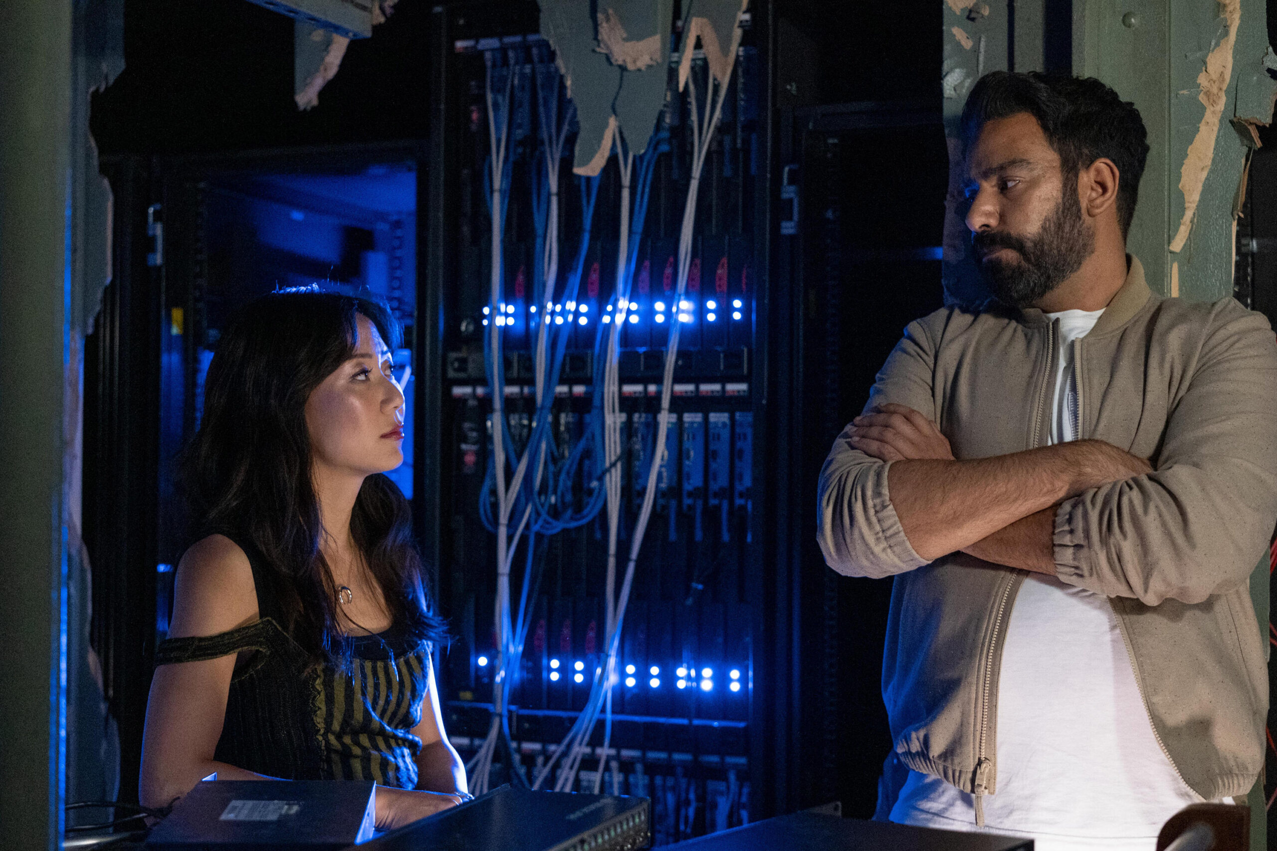 Still from Death and Other Details Season 1 Episode 10 of Angela Zhou as Teddy Goh and Rahul Kohli as Sunil Ranja pictured from left to right.