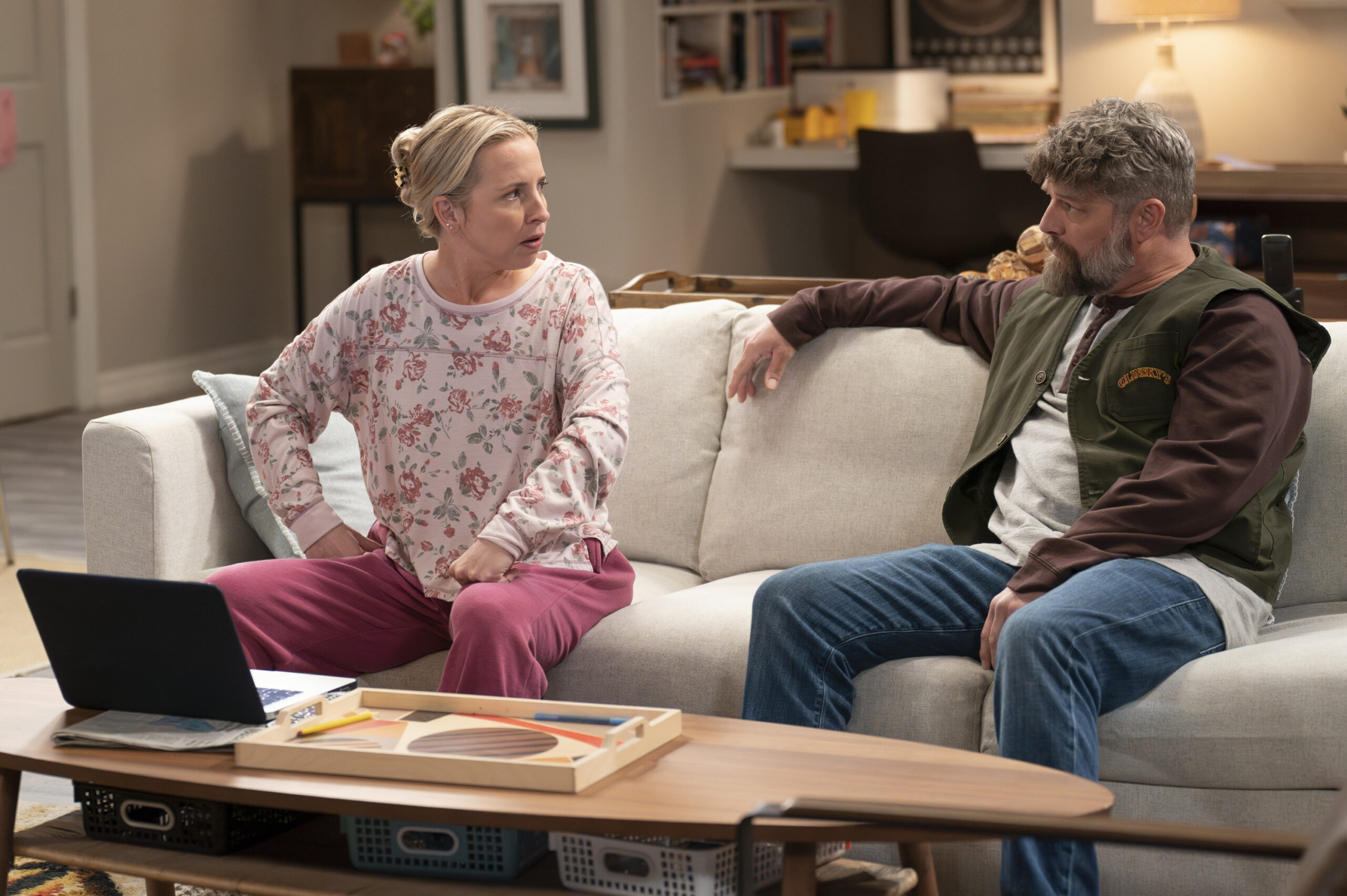 LECY GORANSON, JAY R. FERGUSON | Tell-Tale TV The Conners Season 6 Episode 9 - LECY GORANSON sits on the couch with JAY R. FERGUSON and has a discussion.