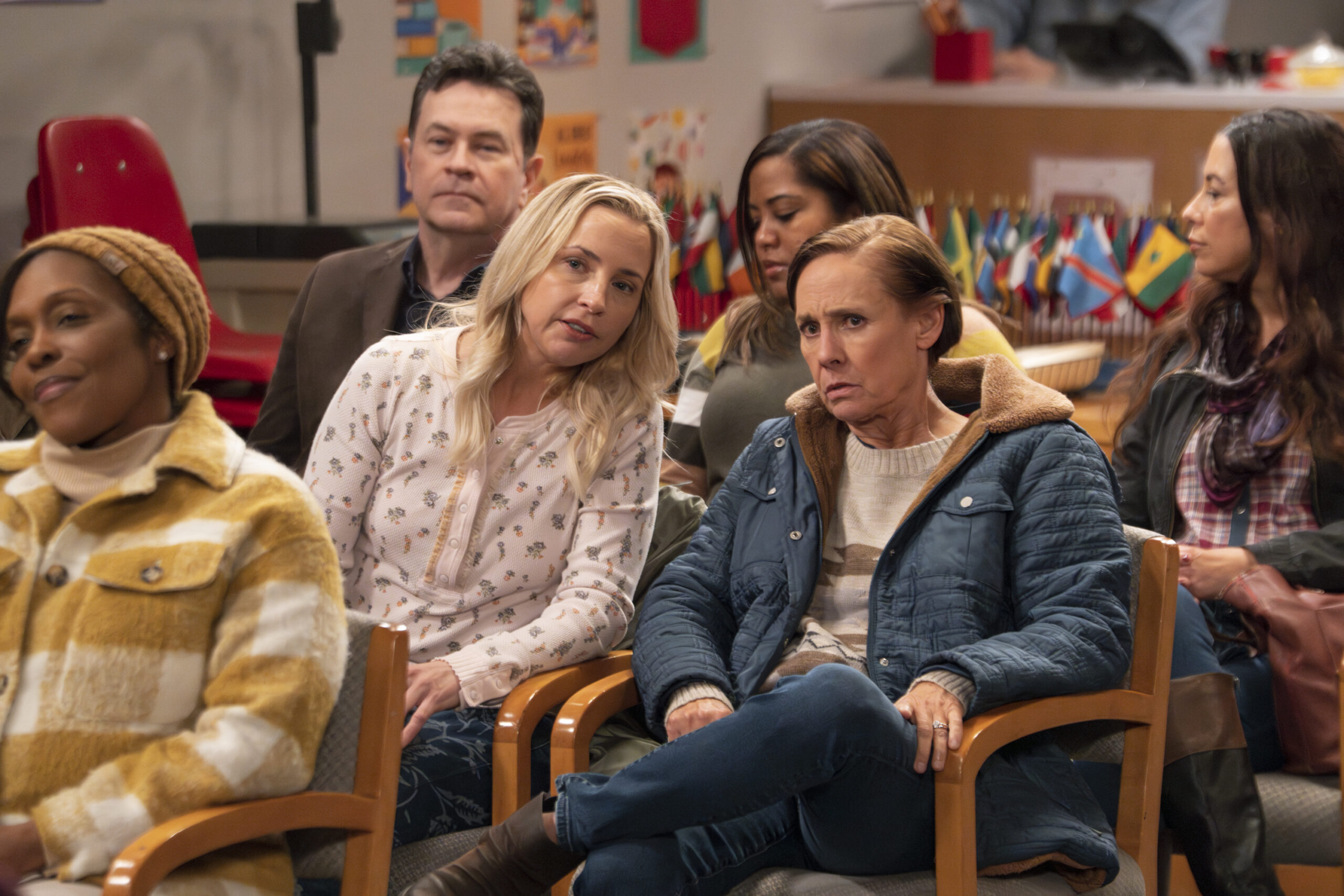 LECY GORANSON, LAURIE METCALF | Tell-Tale TV The Conners Season 6 Episode 10 - LECY GORANSON whispers to LAURIE METCALF, who looks concerned, at the school board election meeting.