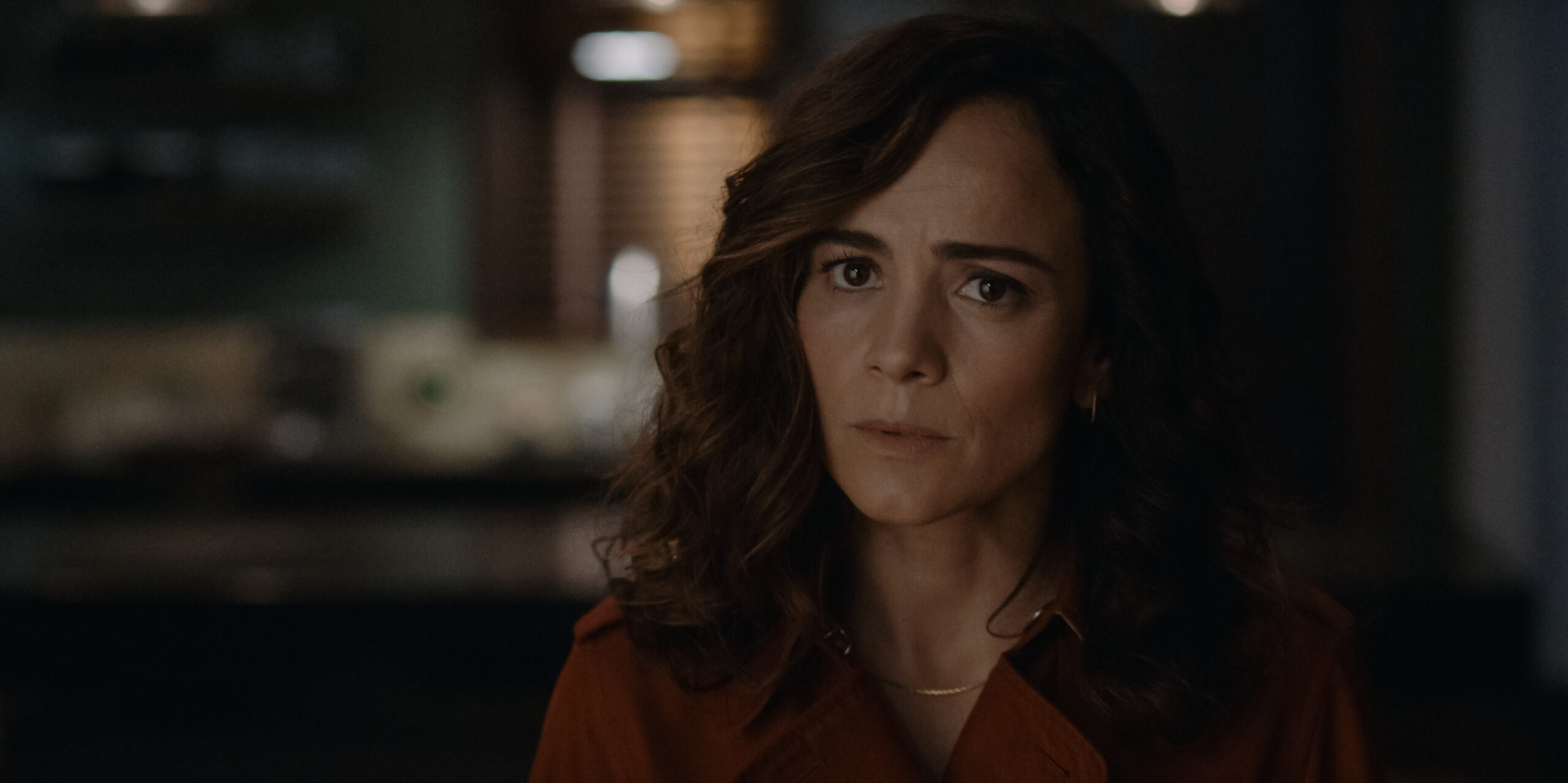 Dark Matter Season 1 Episode 1: Alice Braga | Tell-Tale TV Still from Dark Matter Season 1 Episode 1 of Alice Braga in a medium shot wearing a dark red blouse.