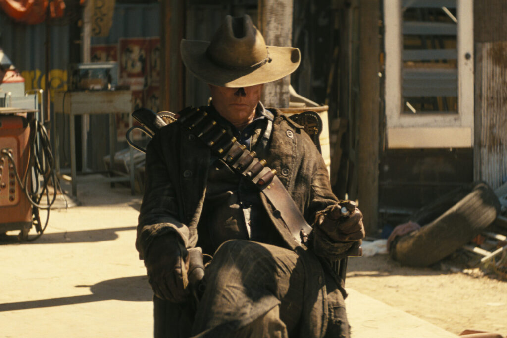 Fallout Season 1 Episode 2, "The Target" | Tell-Tale TV Fallout Season 1 Episode 2, "The Target." Walton Goggins as The Ghoul sitting in a chair looking down