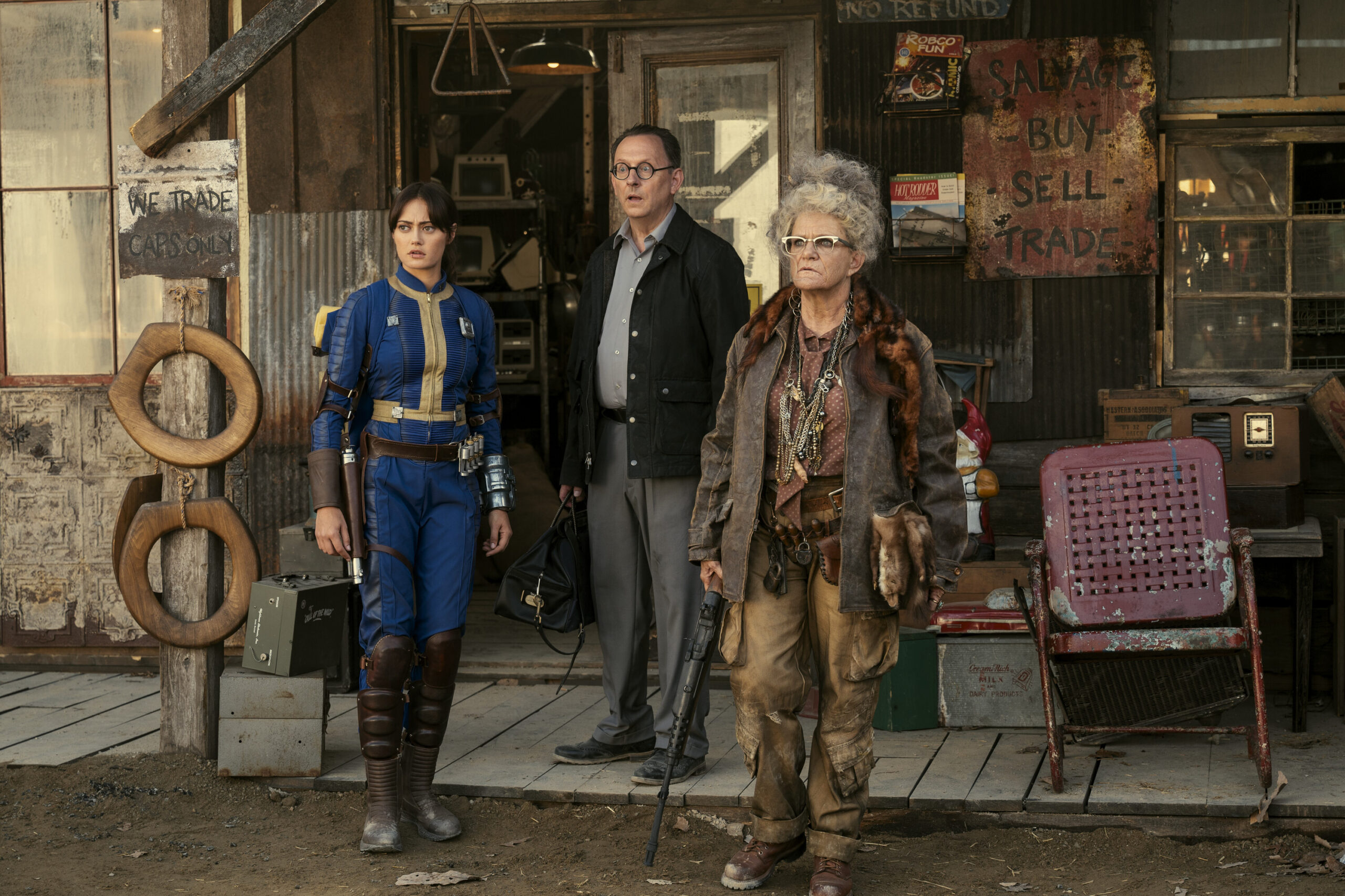 Fallout Season 1 Episode 2, "The Target" | Tell-Tale TV Fallout Season 1 Episode 2. Lucy, Dr. Wilzig, and Ma June, looking at something