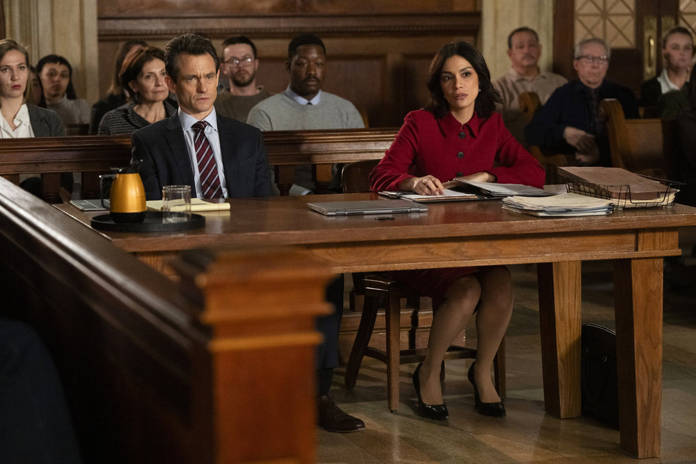 Law & Order Season 23 Episode 9 - Hugh Dancy as ADA Nolan Price sits with Odelya Halevi as ADA Samantha Maroun in court.