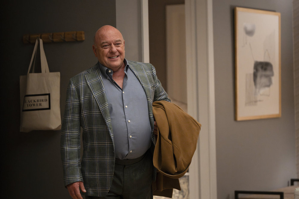 Law & Order: Organized Crime Season 4 Episode 9 - Dean Norris as Randall Stabler in his new home smiling with his coat under his arm.