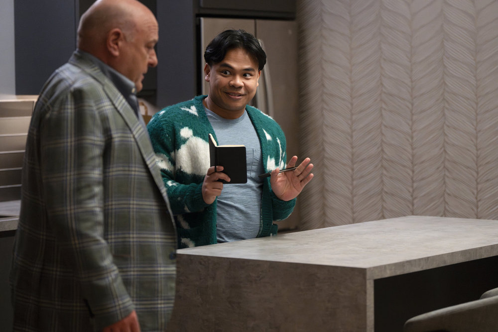 Law & Order: Organized Crime Season 4 Episode 9 - Dean Norris as Randall Stabler oversees the set up of furniture with Julian Fadullan as Gabriel.