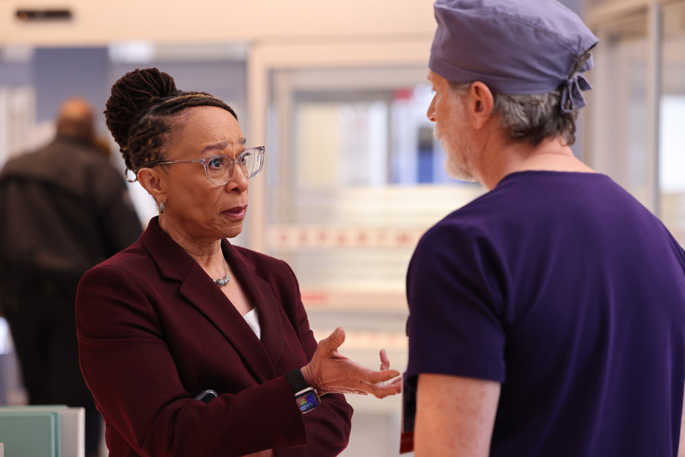 Chicago Med - Season 9 | Tell-Tale TV Chicago Med Season 9 Episode 10 - Epatha Merkerson as Sharon Goodwin stands with a serious look on her face and her hand extended to Steven Weber as Dr. Dean Archer as they discuss something.