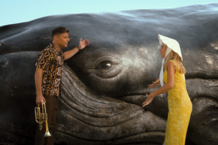 Robert and Maxine stand in front of a beached whale while gesturing wildly on Palm Royale Season 1 Episode 8, "Maxine Saves the Whale."