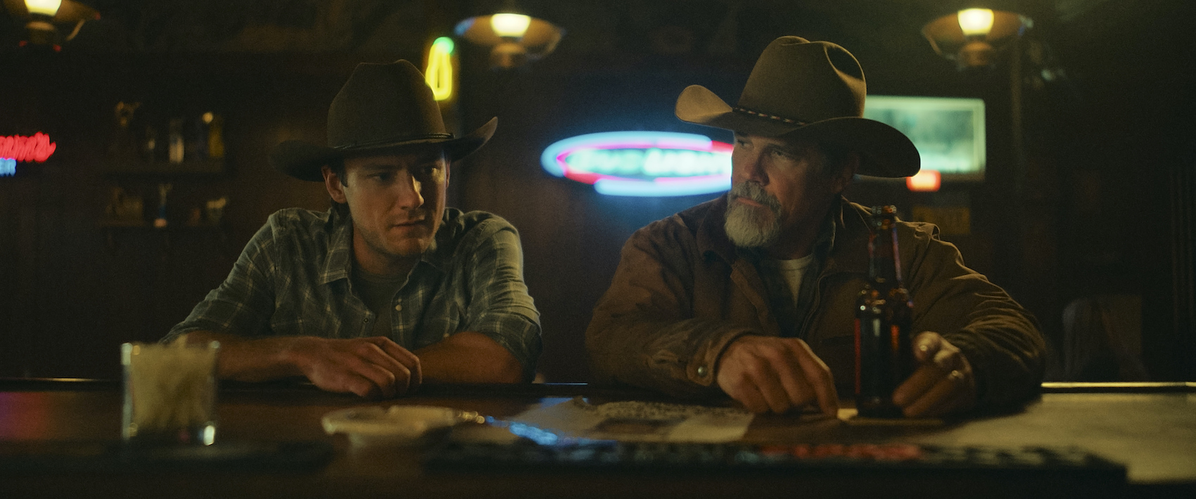 Outer Range Season 2 | Tell-Tale TV Outer Range Season 2 Rhett Abbott (Lewis Pullman) and Royal Abbott (Josh Brolin) at a bar