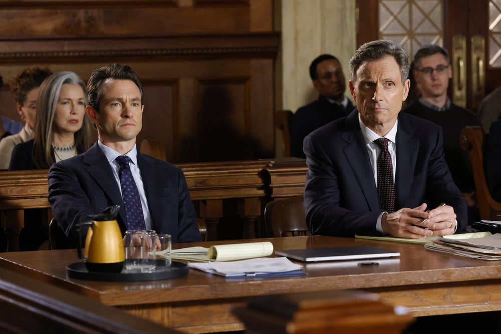 Law & Order - Season 23 | Tell-Tale TV Law & Order Season 23 Episode 12 - Hugh Dancy as Assistant District Attorney Nolan Price and Tony Goldwyn as DA Nicholas Baxter sit in the courtroom during trial.
