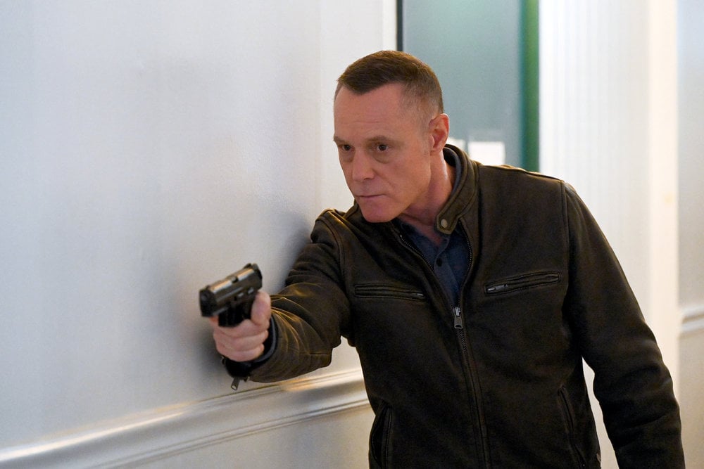 Chicago P.D. Season 11 Episode 12 - Jason Beghe as Hank Voight slowly approaches a situation with his gun drawn.