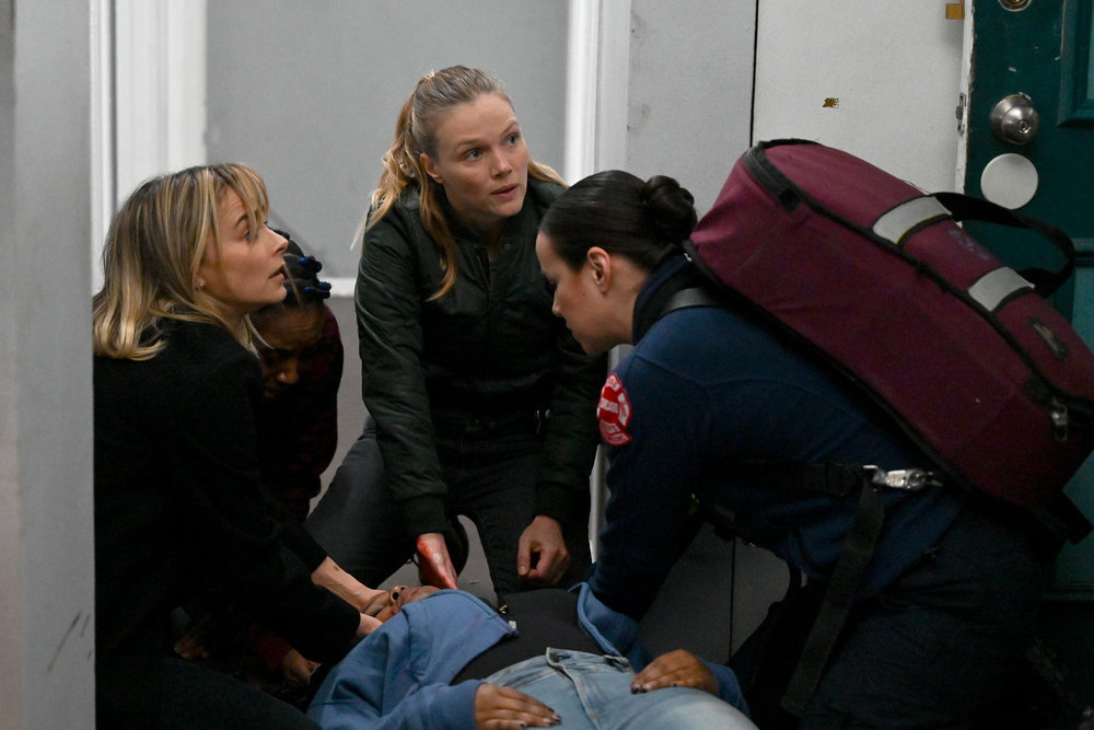 Chicago P.D. Season 11 Episode 12 - Bojana Novakovic as Josephine Petrovic and Tracy Spiridakos as Hailey Upton try to help a woman who is on the ground.