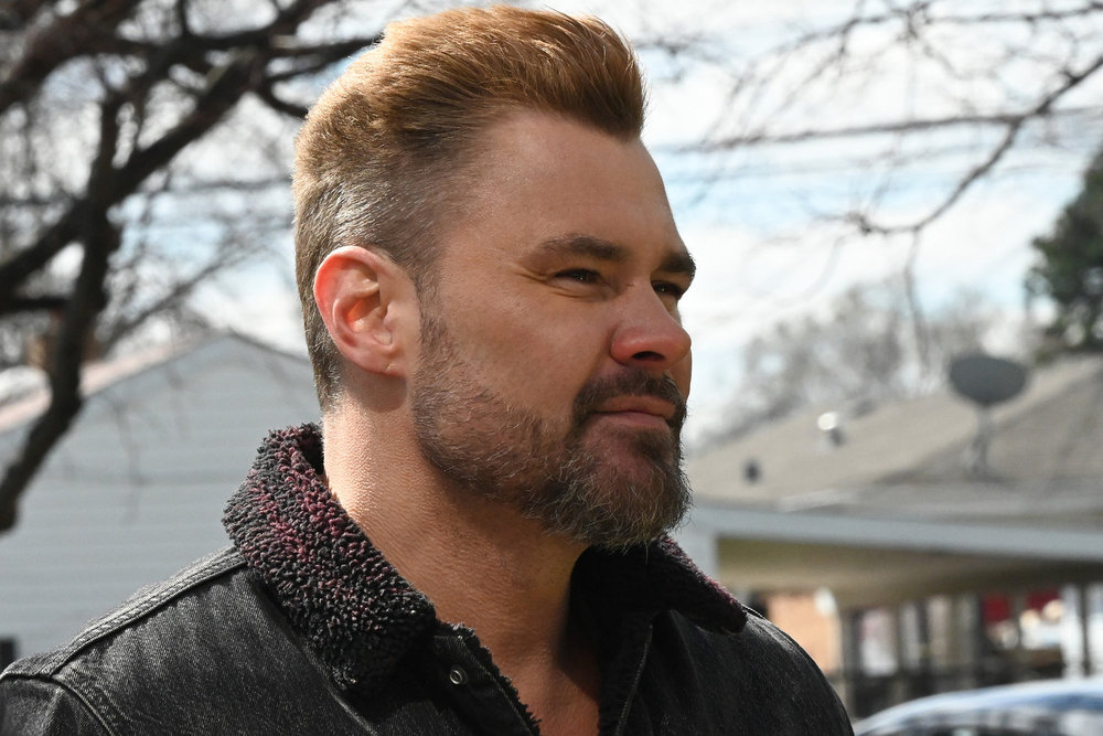 Chicago P.D. Season 11 Episode 12 - Patrick John Flueger as Adam Ruzek stands outside.