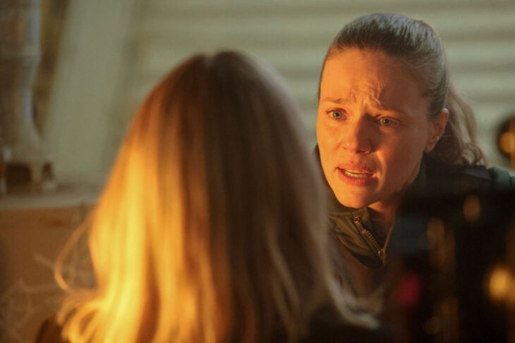 Chicago P.D. Season 11 Episode 13 - Tracy Spiridakos as Hailey Upton looks urgently upset as she speaks to a woman with her back to the camera.