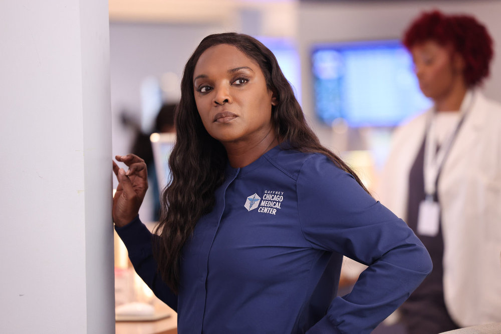 Chicago Med Season 9 Episode 13 - Marlyne Barrett as Maggie Lockwood stands observing.