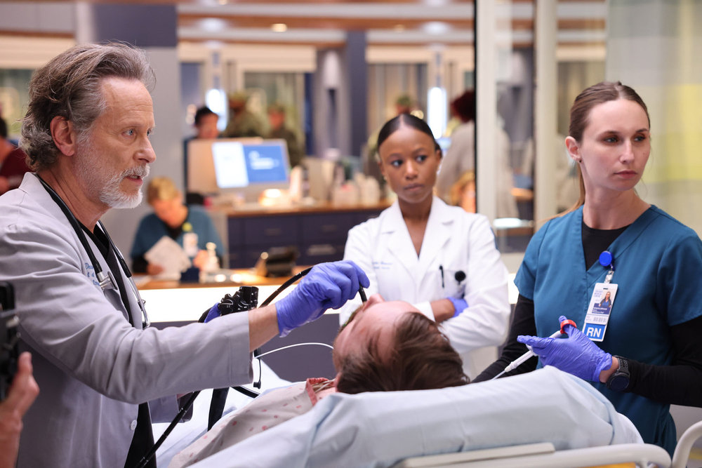 Chicago Med - Season 9 | Tell-Tale TV Chicago Med Season 9 Episode 13 - Steven Webber as Dr. Dean Archer scopes a patient as Ashlei Sharp Chestnut as Naomi Howard stands by and observes.