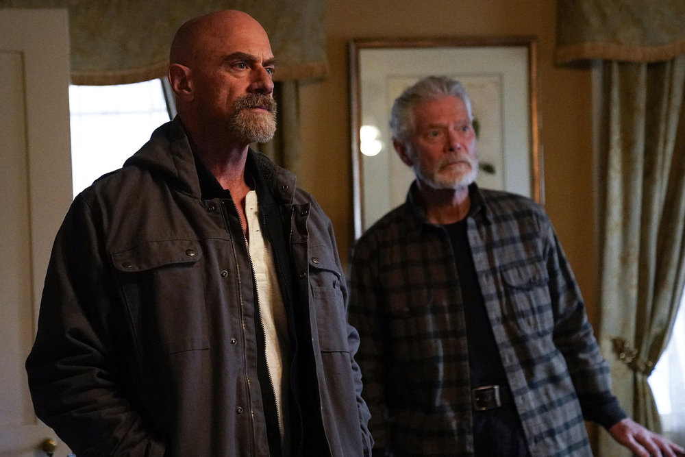 Law & Order: Organized Crime - Season 4 | Tell-Tale TV Law & Order: Organized Crime Season 4 Episode 11 - Christopher Meloni as Det. Elliot Stabler stands with Stephan Lang as Angus Boone inside one of the farm's houses.