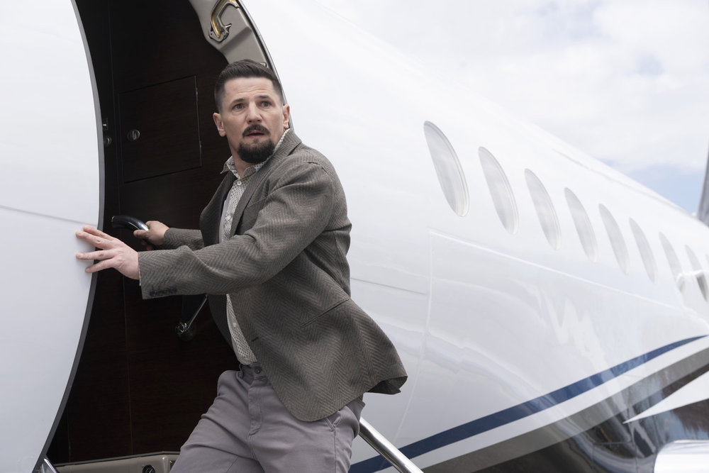 Law & Order: Organized Crime - Season 4 | Tell-Tale TV Law & Order: Organized Crime Season 4 Episode 13 - Michael Trotter as Joseph Stabler Jr. climbs on Emery's plane while looking over his shoulder, concerned.