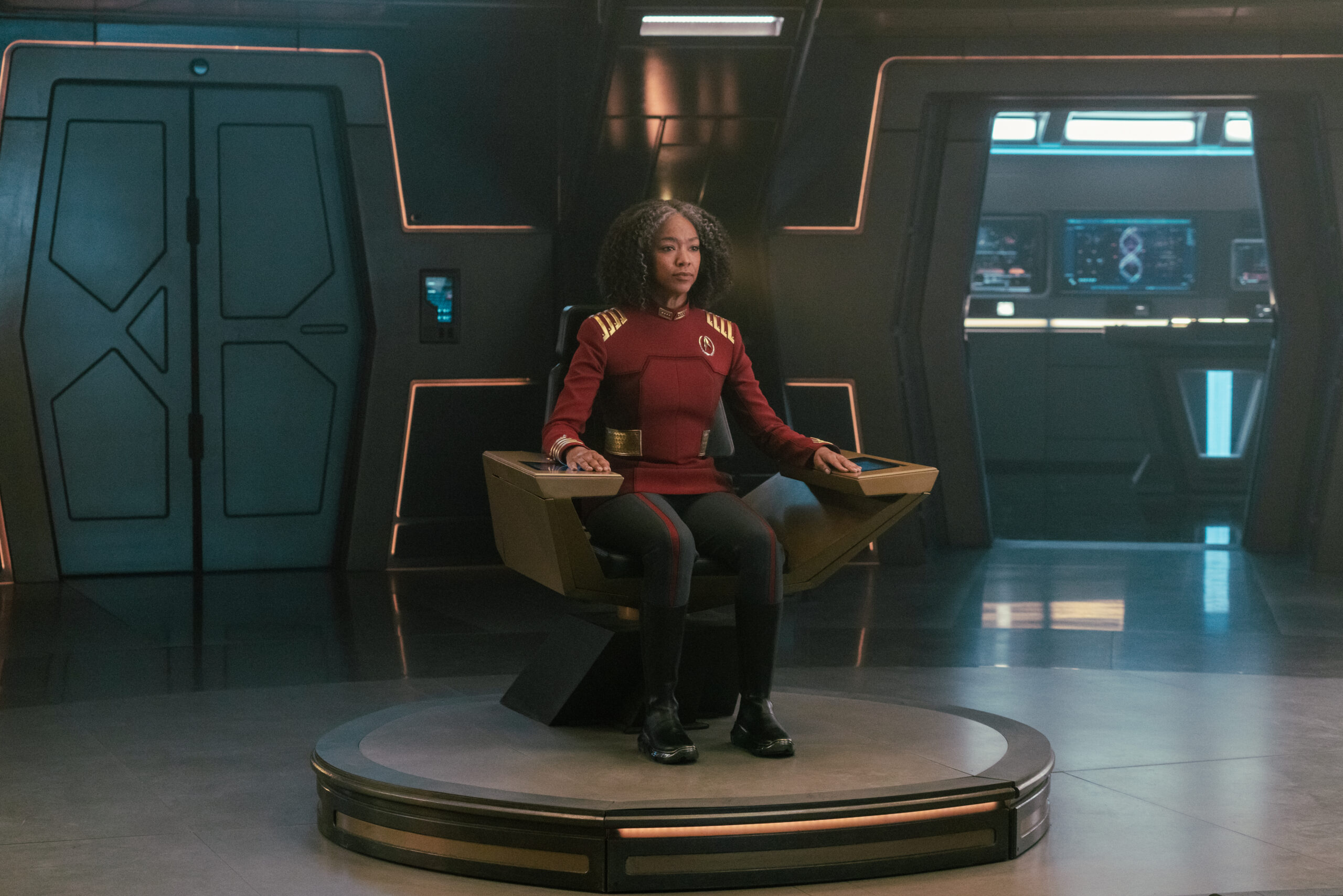 Admiral Burnham sits in the captain's chair on the bridge of the U.S.S. Discovery on Star Trek: Discovery Season 5 Episode 10, "Life, Itself."