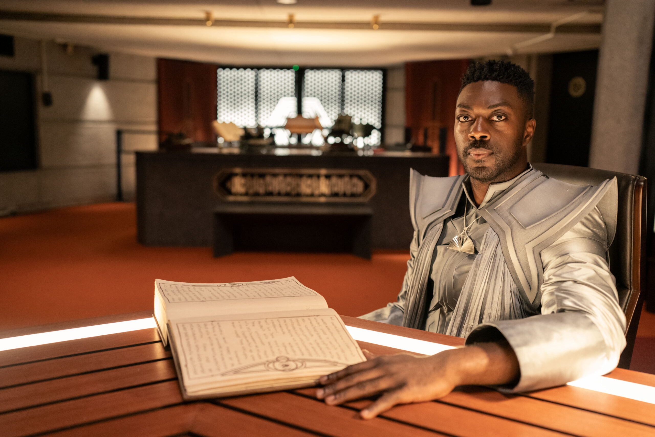 Book wears a silver gown while sitting at a table in the Archive on Star Trek: Discovery Season 5 Episode 8, "Labyrinths." Star Trek: Discovery Season 5 Episode 8 Review: Labyrinths