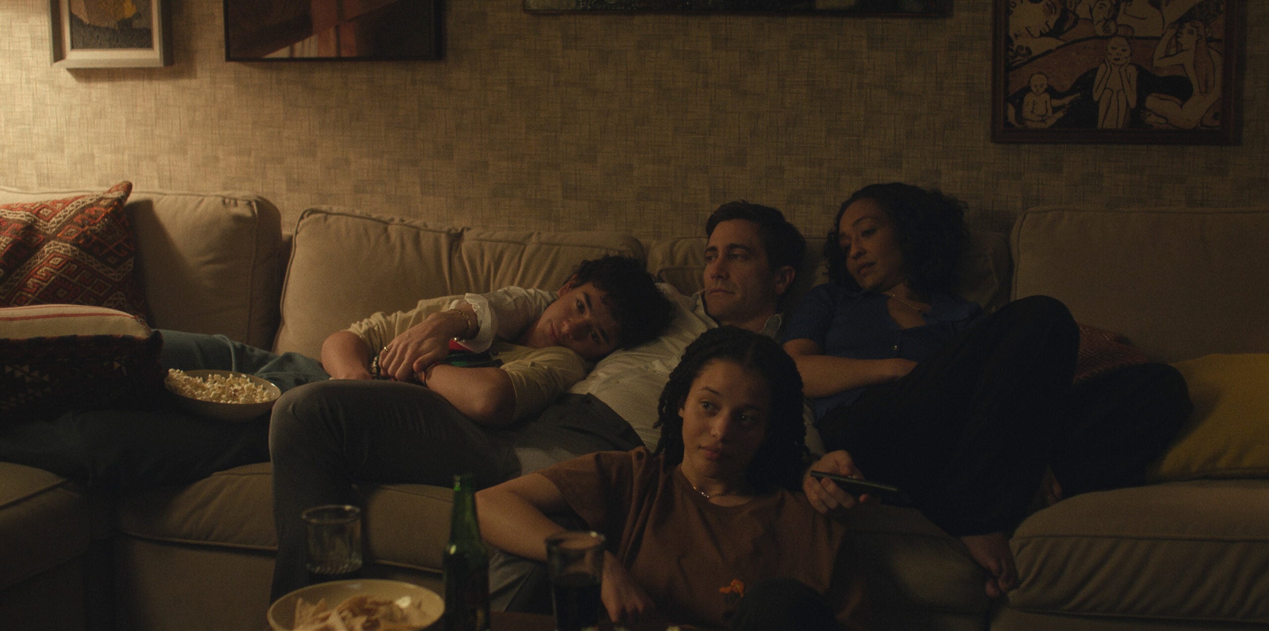 Jake Gyllenhaal on Presumed Innocent sitting on the couch with his family.