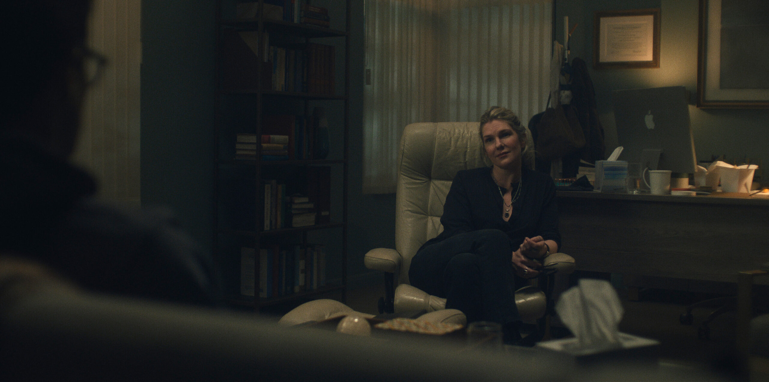 Lily Rabe sitting on an armchair.