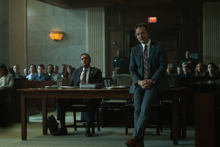 Peter Sarsgaard leaning against a table where O-T Fagbenle is sitting.